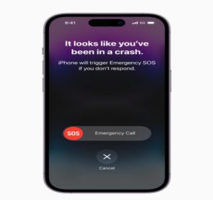 An iPhone 14 displays it's new crash detection alert on a phone screen.